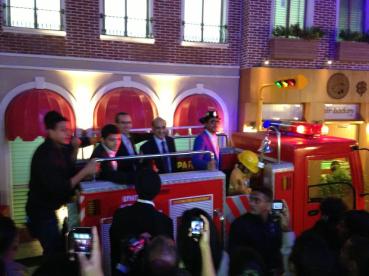 Shah Rukh Khan with Mr. Xavier López riding the Fire Truck at KidZania Mumbai